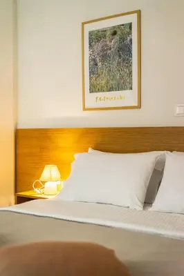 a bedroom with a bed with a picture on the wall at Attica Skyline Living! in Athens