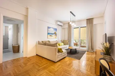 a living room with a couch and a table at Attica Skyline Living! in Athens