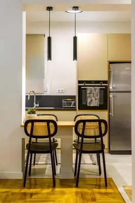 a kitchen with two chairs at a counter with a refrigerator at Attica Skyline Living! in Athens