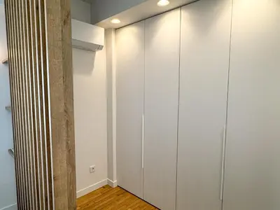 a room with white cabinets and a pillar at Syntagma Spacious Residence in Athens