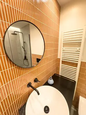 a bathroom with a white sink and a mirror at Syntagma Spacious Residence in Athens