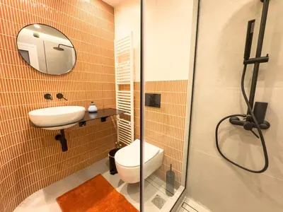 a bathroom with a toilet and a sink and a shower at Syntagma Spacious Residence in Athens