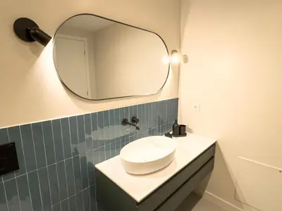 a bathroom with a sink and a mirror on the wall at Syntagma Spacious Residence in Athens