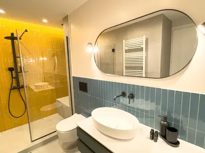 a bathroom with a sink and a toilet and a mirror at Syntagma Spacious Residence in Athens