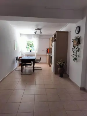 a living room with a table and a kitchen at Charming Flat in Central Athens in Athens