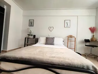 a bedroom with a large bed with a heart on the wall at Charming Flat in Central Athens in Athens
