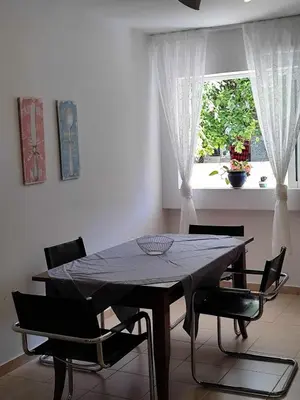 a dining room table with chairs and a window at Charming Flat in Central Athens in Athens