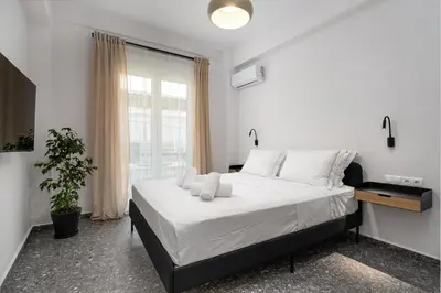 a bedroom with a large bed and a window at Stylish Retreat in Quiet Piraeus Newly Renovated in Piraeus