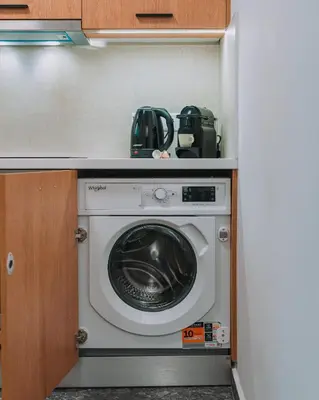 a washer and dryer in a small kitchen at Stylish Retreat in Quiet Piraeus Newly Renovated in Piraeus
