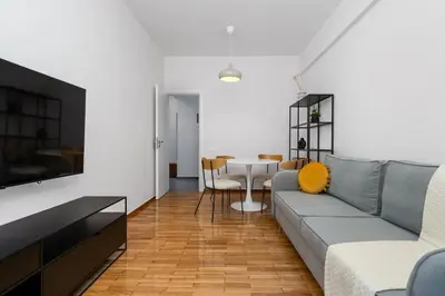 a living room with a couch and a table at Stylish Retreat in Quiet Piraeus Newly Renovated in Piraeus