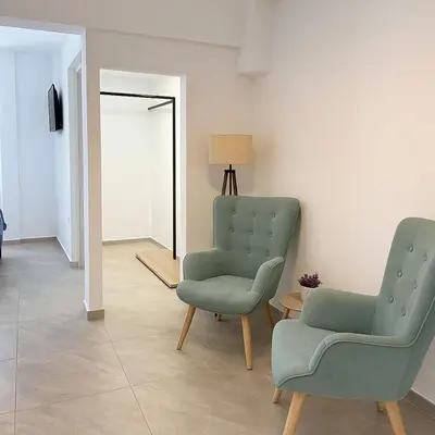 two chairs and a table in a room at Athenian Stay 601 Apartment in Athens