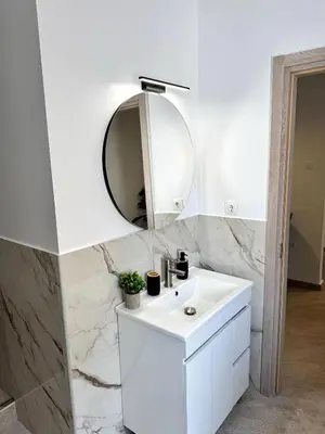 a white bathroom with a sink and a mirror at Athenian Stay 601 Apartment in Athens