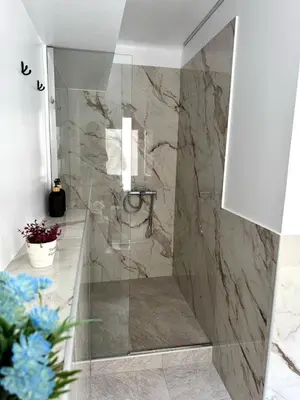 a bathroom with a shower with a glass door at Athenian Stay 601 Apartment in Athens