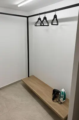 a room with white walls and a shelf with a helmet at Athenian Stay 601 Apartment in Athens
