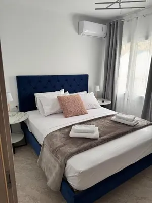 a bedroom with a large bed with two towels on it at Athenian Stay 605 Apartment in Athens