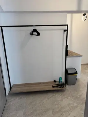 a room with a white wall with a wooden treadmill at Athenian Stay 605 Apartment in Athens