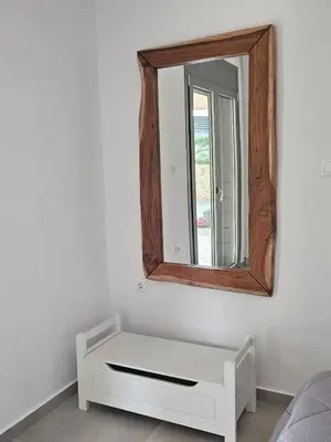 a mirror on a wall with a white dresser at Olive Ridge in Porto Rafti