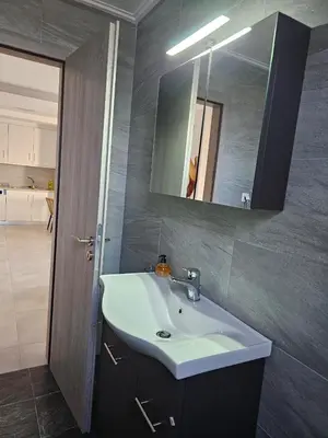 a bathroom with a white sink and a mirror at Olive Ridge in Porto Rafti