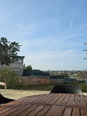 a wooden table with a view of the city at Olive Ridge in Porto Rafti