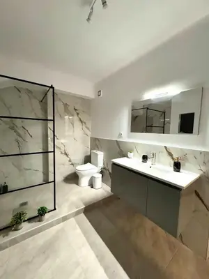 a bathroom with a sink and a toilet and a mirror at Athenian Stay 606 Apartment in Athens