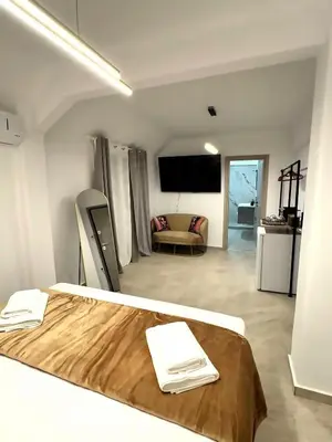 a bedroom with a bed and a living room at Athenian Stay 606 Apartment in Athens