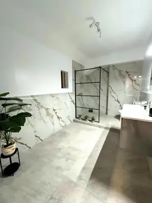 a bathroom with a sink and a marble wall at Athenian Stay 606 Apartment in Athens