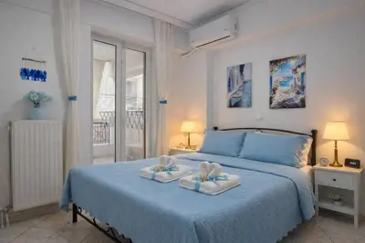 a bedroom with a blue bed with two towels at Acropolis Dream Apartment - 50sqm 2BR Big Living Room with Large Terrace Next to Siggrou FIX Subway Station in the City Center in Athens