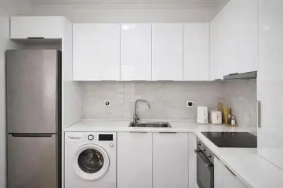 a white kitchen with a washing machine and a sink at Acropolis Dream Apartment - 50sqm 2BR Big Living Room with Large Terrace Next to Siggrou FIX Subway Station in the City Center in Athens