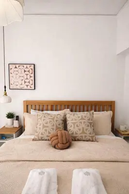 a bedroom with a large bed with two towels on it at Acropolis Dream Apartment - 50sqm 2BR Big Living Room with Large Terrace Next to Siggrou FIX Subway Station in the City Center in Athens
