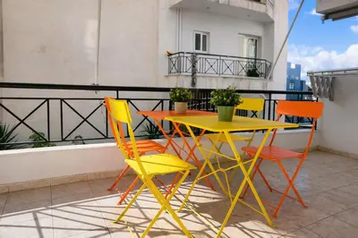 a yellow table and chairs on a balcony at Acropolis Dream Apartment - 50sqm 2BR Big Living Room with Large Terrace Next to Siggrou FIX Subway Station in the City Center in Athens