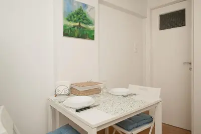 a white table with two plates on top of it at Stef's Place Porto Rafti in Porto Rafti