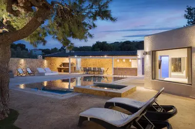 a backyard with a swimming pool and a house at Aeolia Villa Athenian Riviera in Anavissos