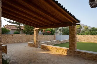 a pavilion with a green lawn in a backyard at Aeolia Villa Athenian Riviera in Anavissos