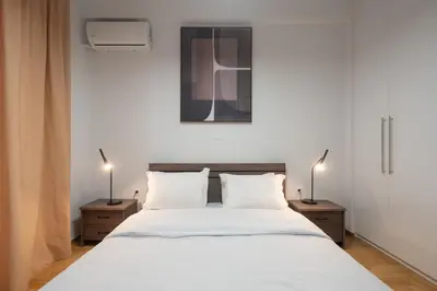 a bedroom with a large white bed with two night stands at 2BR Modern Comfort Top Location in Athens