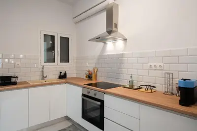 a white kitchen with a sink and a stove at 2BR Modern Comfort Top Location in Athens