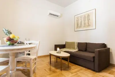 a living room with a couch and a table at Restored Historic APT in Plaka,Under the Acropolis in Athens