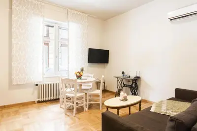 a living room with a couch and a table at Restored Historic APT in Plaka,Under the Acropolis in Athens