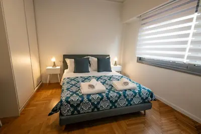 a bedroom with a bed with two towels on it at Comfy 2BR Flat in Central Athens in Athens