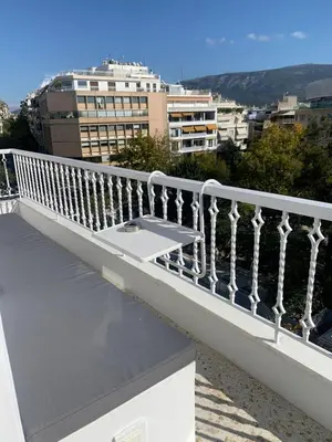 a balcony with a white railing on a building at Art Gallery Apartment in Athens