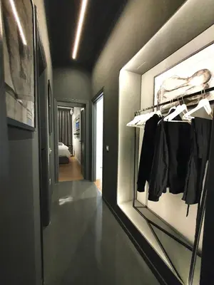 a room with a hallway with a shelf with clothes at Art Gallery Apartment in Athens