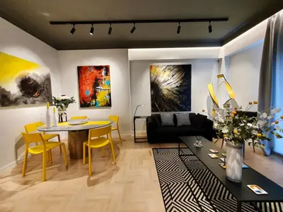 a living room with a table and yellow chairs at Art Gallery Apartment in Athens