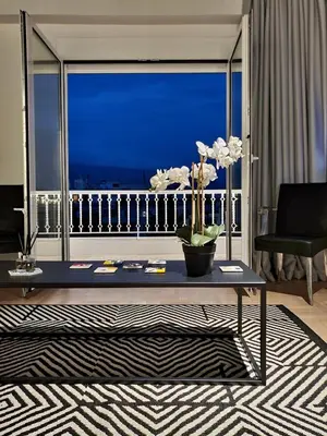 a living room with a table and a view of the ocean at Art Gallery Apartment in Athens