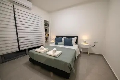 a bedroom with a bed with two towels on it at Smoothie 2Bdr City Center Flat in Athens