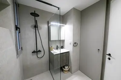 a bathroom with a glass shower and a sink at Smoothie 2Bdr City Center Flat in Athens