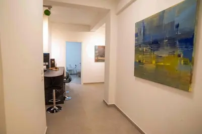 a hallway with a large painting on the wall at Smoothie 2Bdr City Center Flat in Athens