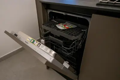 an open dishwasher with its door open in a kitchen at Smoothie 2Bdr City Center Flat in Athens