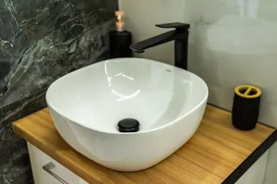 a white sink on a wooden counter in a bathroom at Artemis Modern Apartment II in Athens