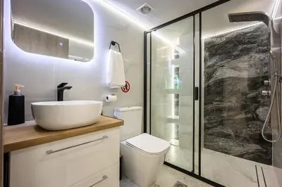 a bathroom with a toilet and a sink and a shower at Artemis Modern Apartment II in Athens