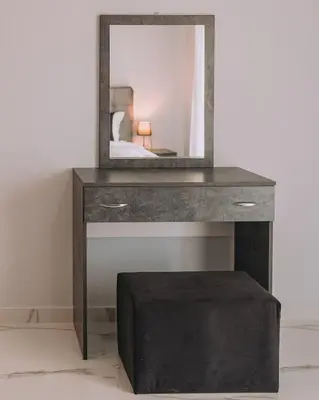 a mirror on top of a table with a stool at Alexander Home in Vravrona