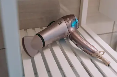 a hair dryer sitting on top of a white bench at Alexander Home in Vravrona